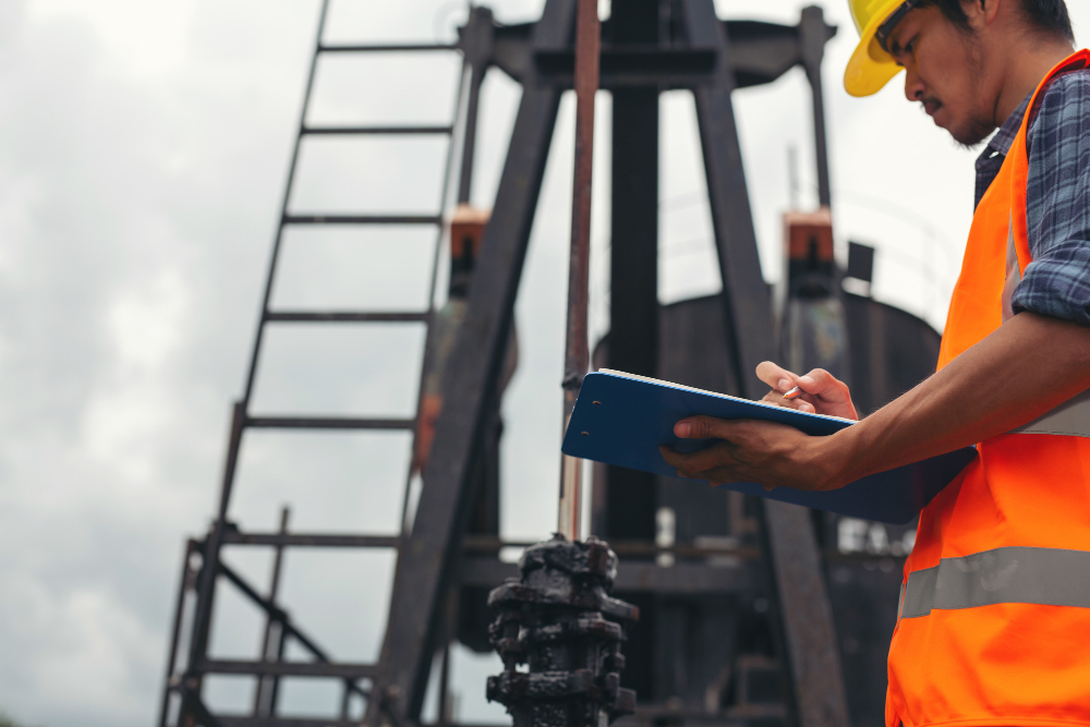 workers-standing-checking-beside-working-oil-pumps